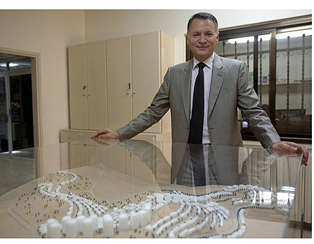 Bashar Masri standing beside a detailed architectural model of the Rawabi City development