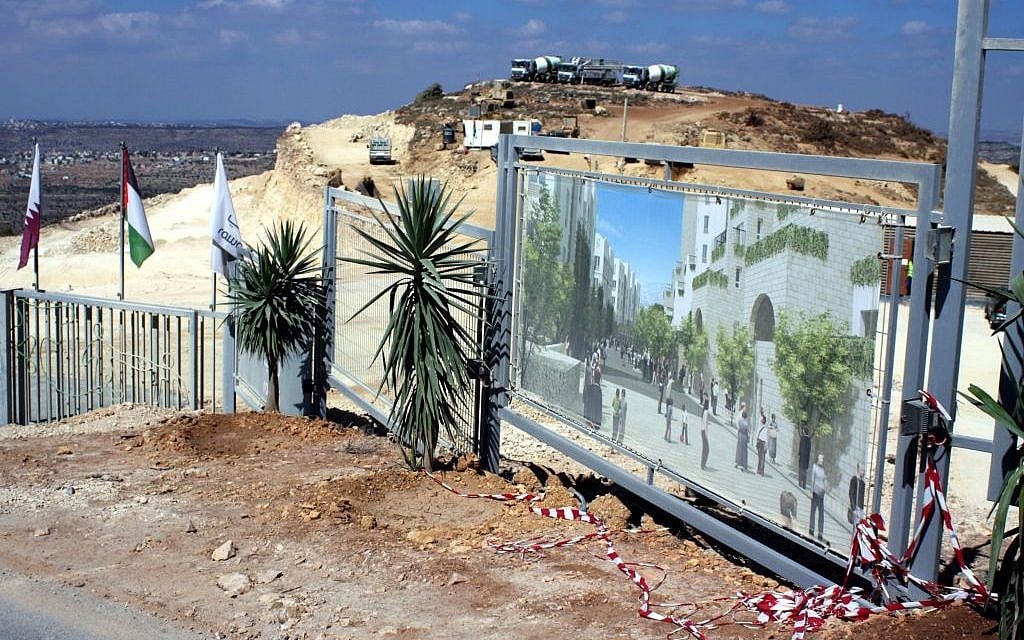 Rawabi City construction site with Palestinian flags and a large architectural rendering of the planned development