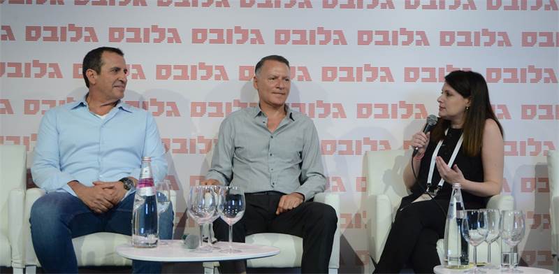 Bashar Masri seated between Eyal Waldman and moderator Naama Sikuler during a panel discussion